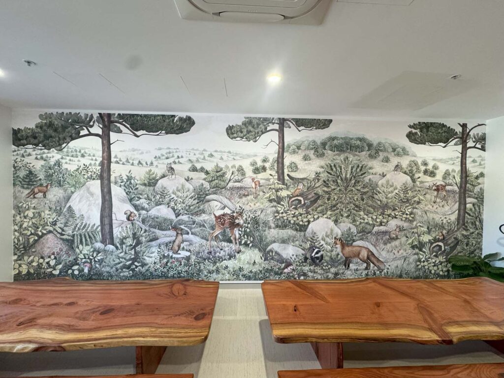 Wallpaper installation by Southern Highlands Painting and Wallpapering with 2 wooden tables placed in front of wall