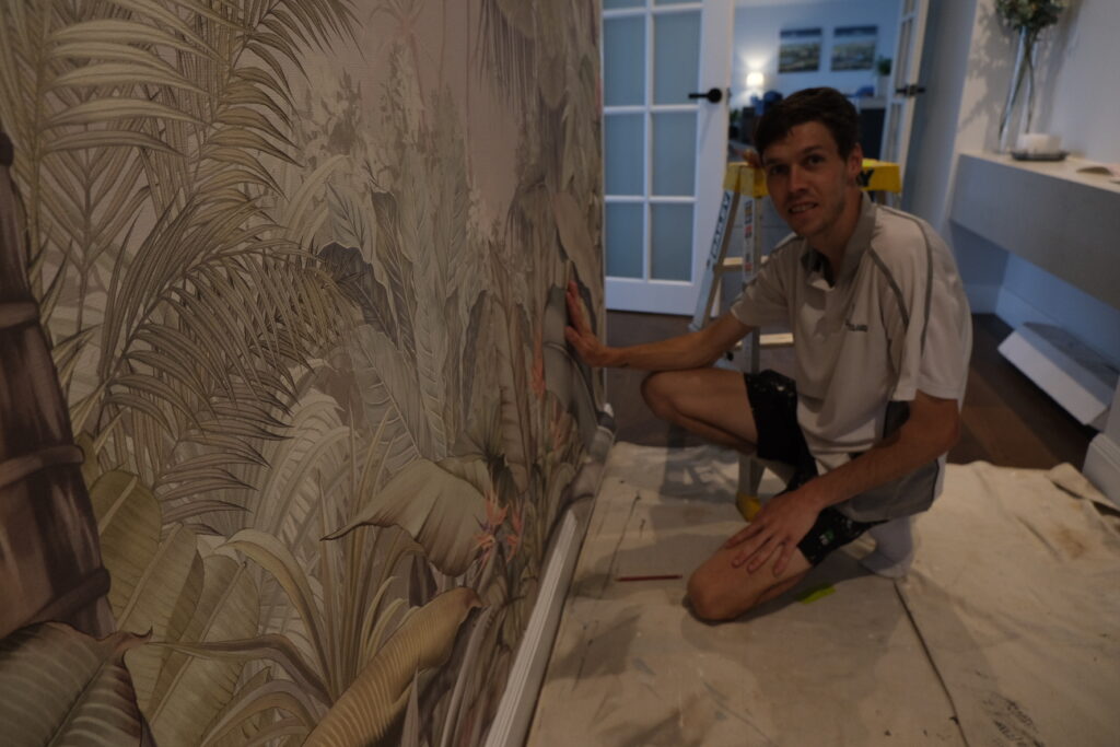 Joel, owner of Southern Highlands Painting and Wallpaper installing a feature wall