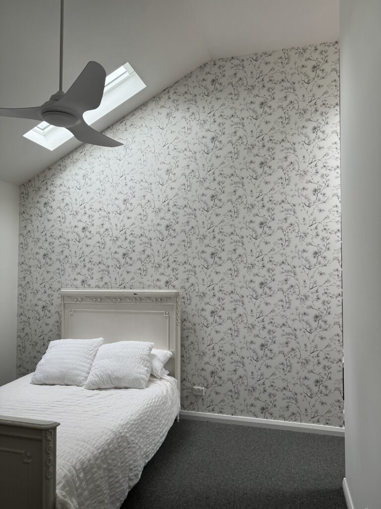 Feature wallpaper wall in bedroom by Southern Highlands Painting and Wallpaper team