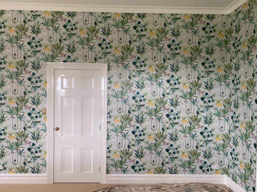 Feature wall decorated with botanical-themed wallpaper in a residential interior by Southern Highlands Painting and Wallpapering, showcasing vibrant floral patterns for stylish home transformations in NSW.