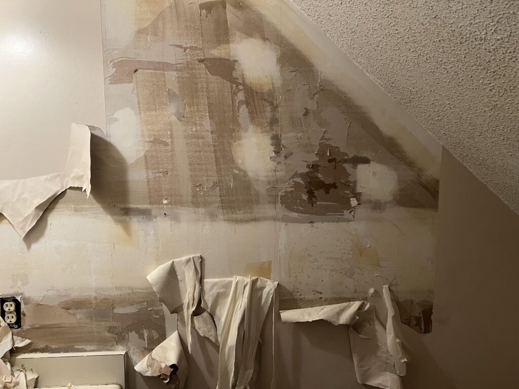 Improper wallpaper removal showing the damage it can cause to a wall