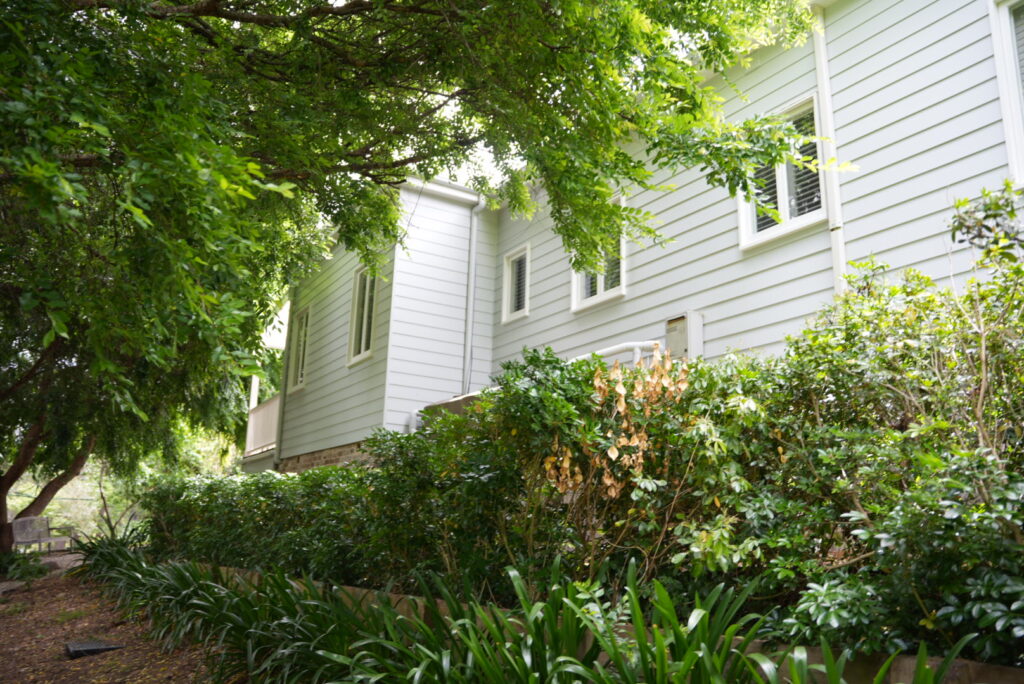 Freshly painted exterior weatherboard home surrounded by greenery in Burradoo, Southern Highlands