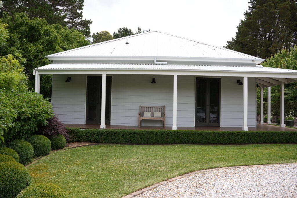 Exterior of home located in Burradoo with wrap around deck and white painted weatherboards