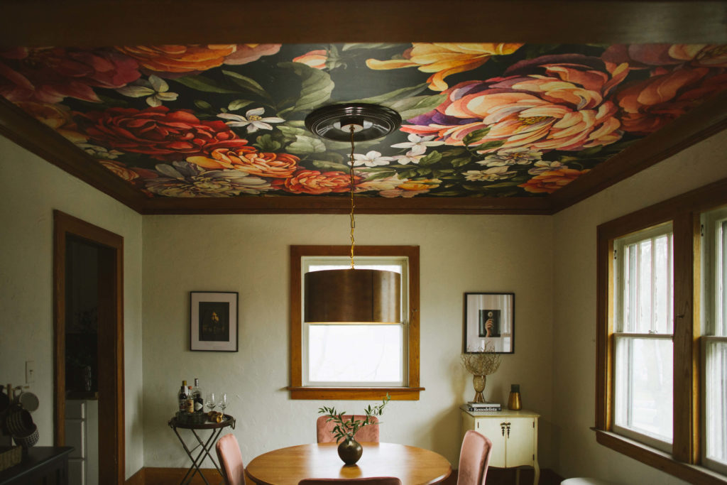 Bold wallpaper with florals installed on ceiling, also known as the "fifth wall"